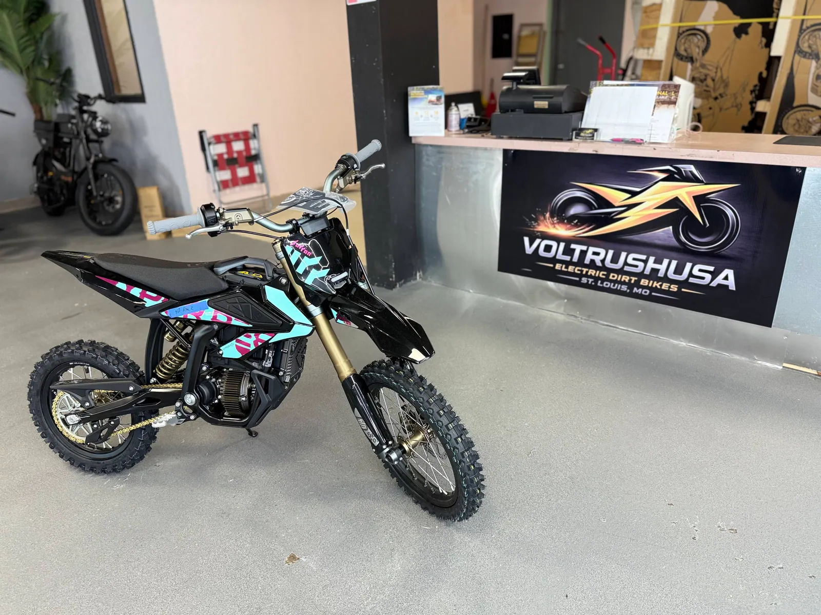 Custom-color electric dirt bike displayed at VoltRush USA