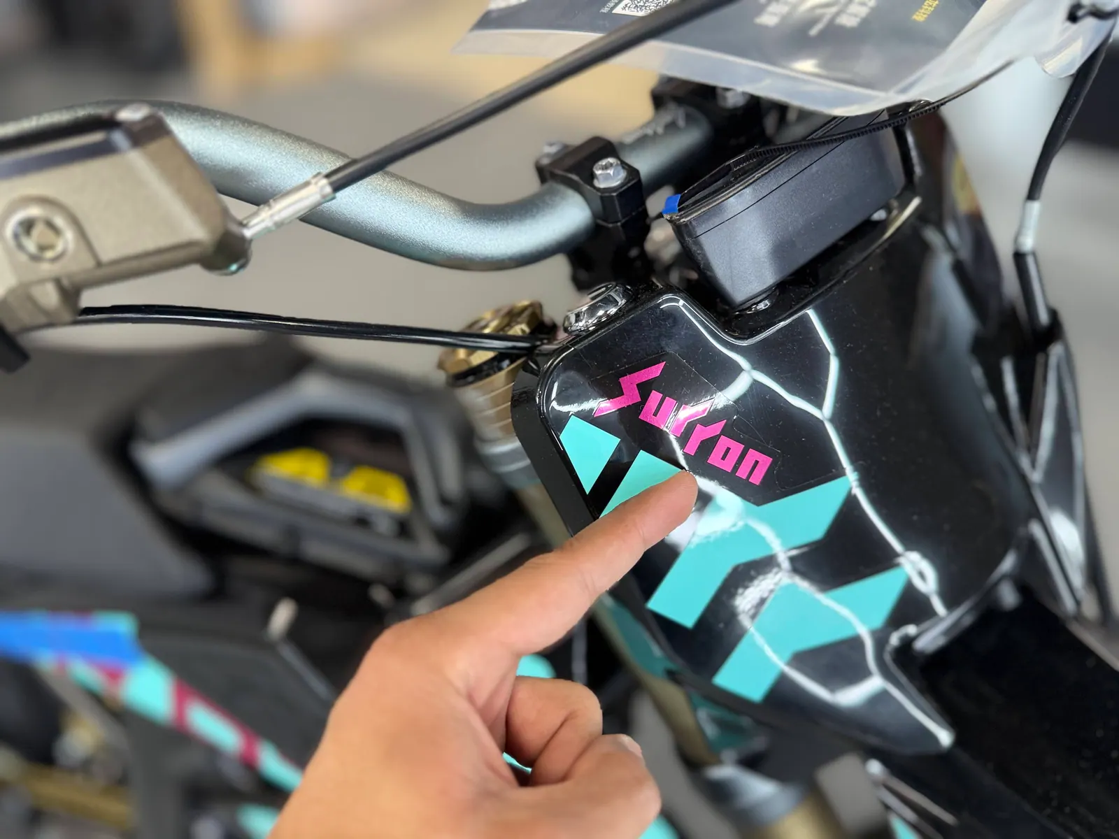 Close view of an electric dirt bike body and frame components at VoltRush USA