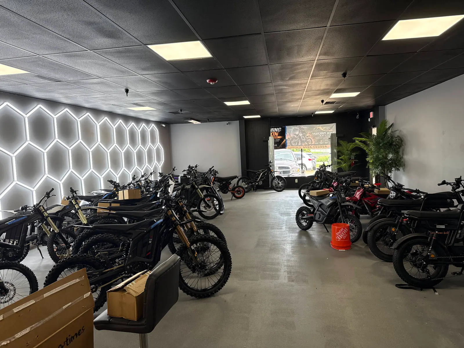 Rows of electric dirt bikes across the VoltRush USA showroom floor